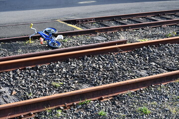 Little kid bike abandoned on railroad tracks.