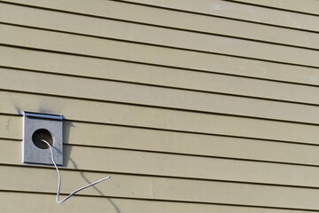 New yellow siding, lighting socket awaiting light install. Wires exposed.