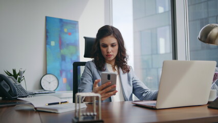 Nervous manager answering phone sitting desk with laptop close up. Stressed lady