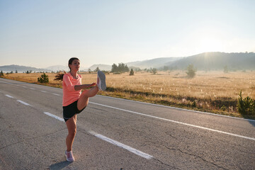 Determined Stretch: Athletic Woman Embraces Post-Run Flexibility in Nature.