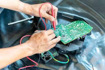 Technician checked air conditioning control board, Repairman fixed air conditioning systems, Technician man service repair and maintenance of air conditioners.