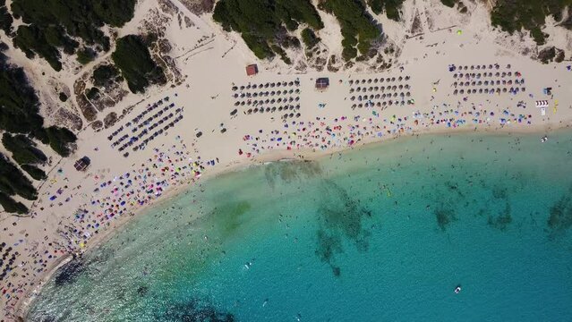 Orbiting drone shot slowly descending above the Cala Agulla bay, in the Llevant Penisula located in the Mediterranean island of Mallorca in Spain.