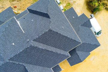 There are asphalt shingles covering roof of newly constructed house - obrazy, fototapety, plakaty