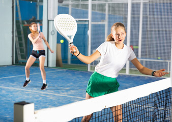 Padel tennis teenage girl in court ready for play and train