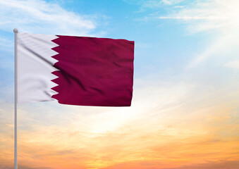 3D illustration of a Qatar flag extended on a flagpole and in the background a beautiful sky with a sunset