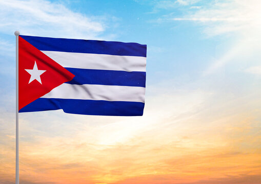 3D illustration of a Cuba flag extended on a flagpole and in the background a beautiful sky with a sunset