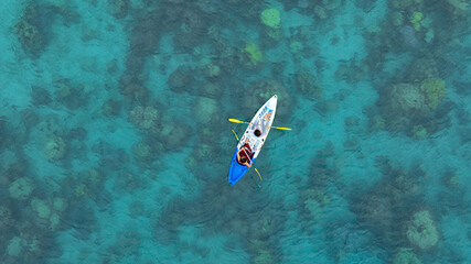 Aerial view of a kayak in the blue sea .Woman kayaking She does water sports activities