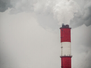 smoke coming out of a large factory chimney. Close-up of smoke coming out of chimneys against the sky. Air pollution concept. color nature