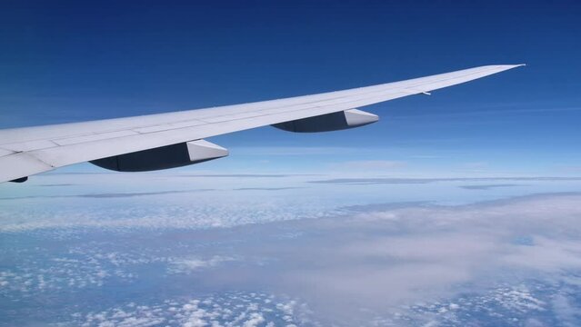 Sleek Wing of the B787 in Flight, Sunny Sky Background