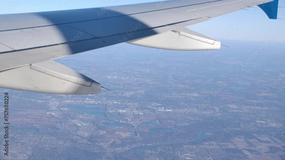 Poster passenger view from flying airplane window trailing edge of wing