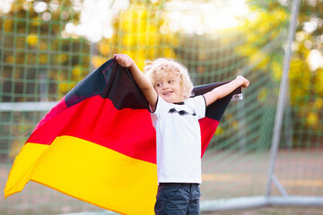 Germany football fan kids. Children play soccer.