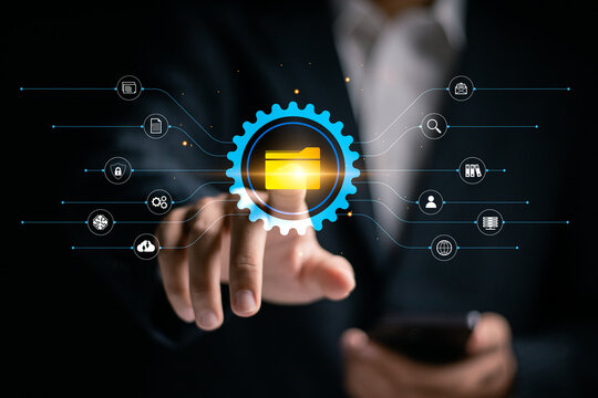 DMS, Document Management System concept, Search and manage document database files online. Businessman touching file folder icon on virtual screen for online documentation database.