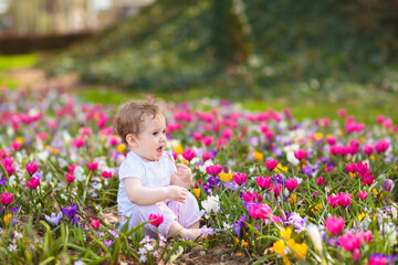 Child in spring park with flowers