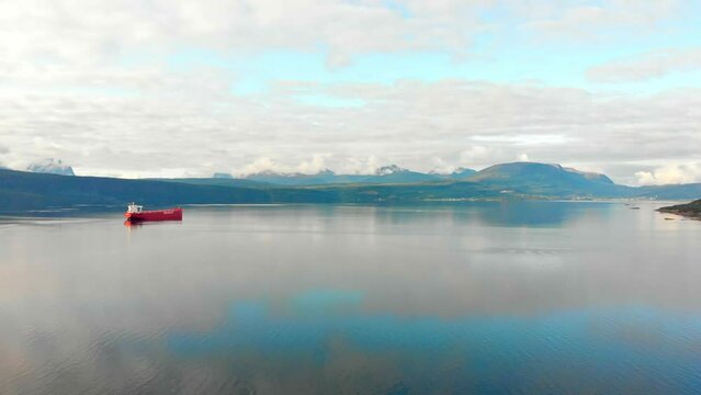 Aerial: red cargo boat in the Fiord of Narvik. Ofotfjorden, norwegian sea