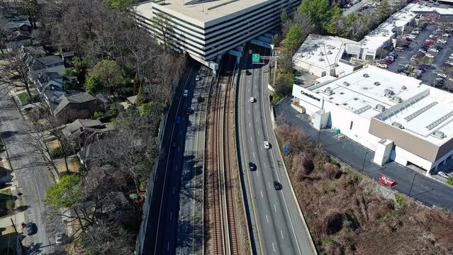 Busy Highway in suburb neighborhood of Atlanta City in sun. Aerial top down shot.