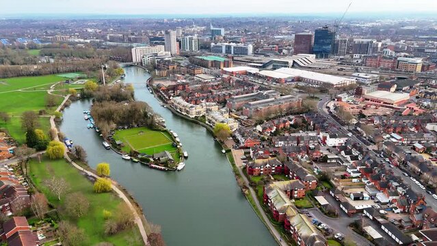 Aerial view slowly rotating around Fry's Island with Reading town skyline in the background
