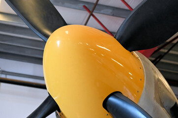 Close up of a Yellow Airplane Cone and Propeller Blades