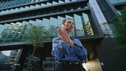 Angry woman shouting smartphone at urban street. Furious businesswoman hung up 