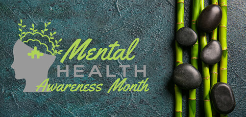 Spa stones and bamboo on dark background, top view