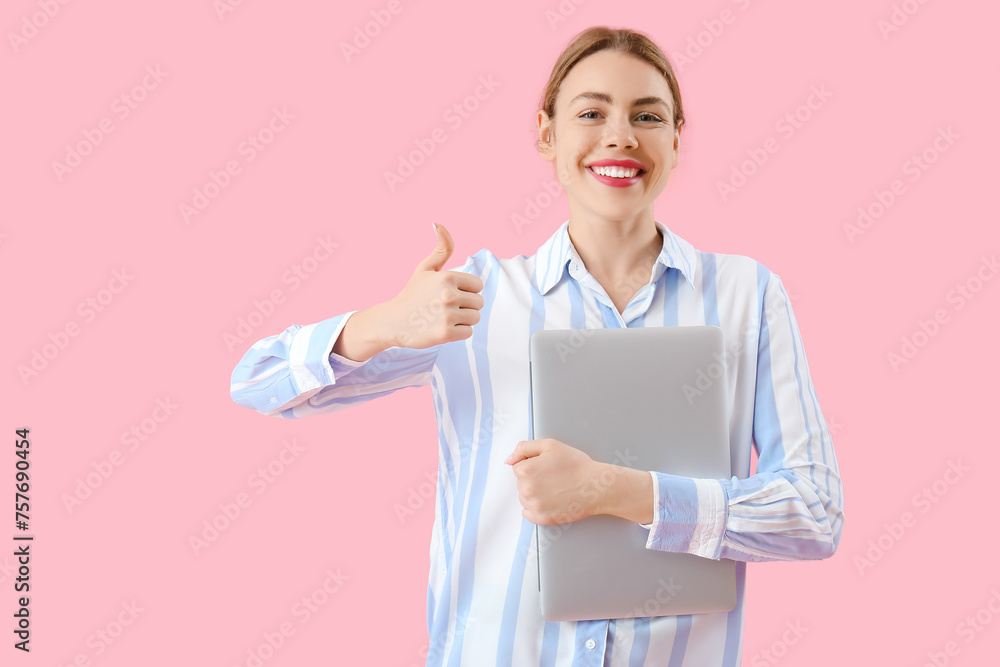Poster female programmer with laptop showing thumb-up on pink background