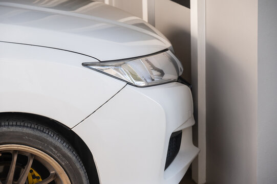 A car crash on house wall. An accident casued by distracted friver.