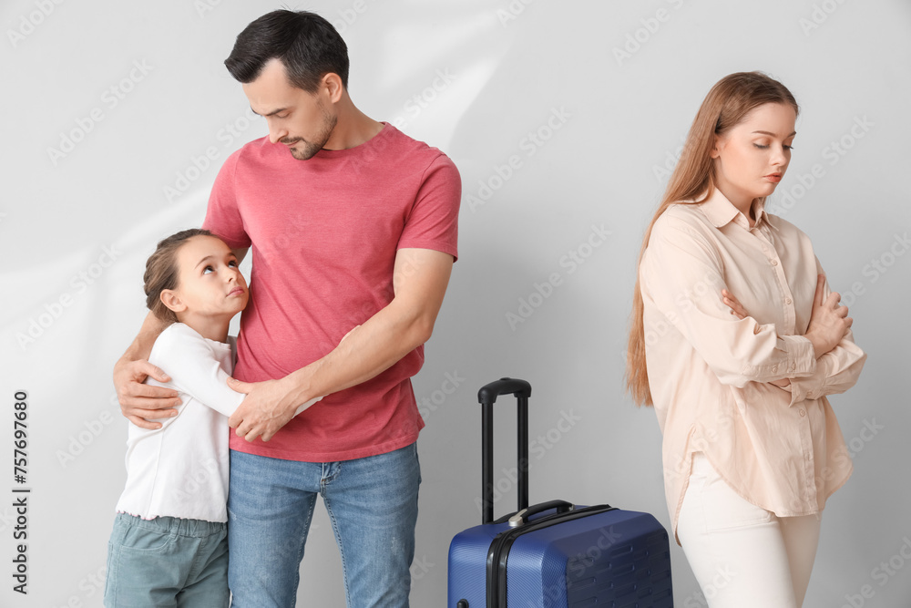 Canvas Prints sad little girl hugging her father before leaving on light background. divorce concept