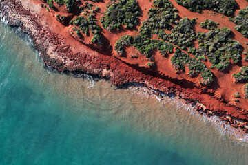 Aerial picture of Cape Peron beach. View from the sky of orange land and  bushes next to the ocean....