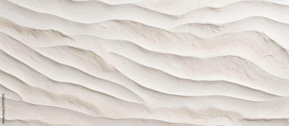 Poster a closeup of a beige sand dune with waves cascading on its surface, creating a beautiful pattern aga