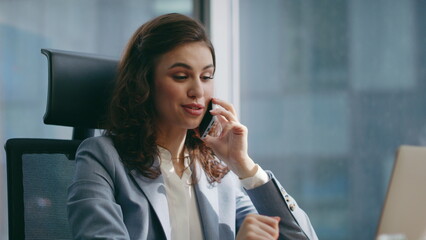 Girl business consultant calling sitting office desk with laptop close up. 