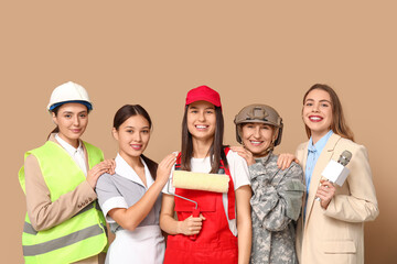 Women of different professions on beige background