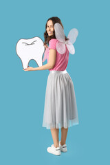 Tooth Fairy with paper figure on blue background