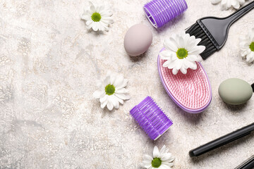 Hairdressing accessories with daisies and Easter eggs on grey grunge background