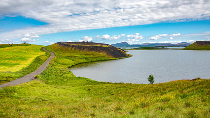 Skutustadagigar pseudo craters of volcanoes at Myvatn lake in Iceland, with tourists walking on...