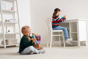 Little girls playing at home. Autistic disorder concept
