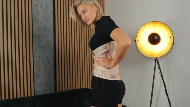 lady patient wearing back pain support belt for orthopedic lumbar, wound care concept