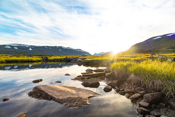 A beautiful small mountain lake in Sarek National Park, Sweden during august. Summer landscape of northern wilderness in Scandinavia.