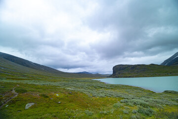 A beautiful small mountain lake in Sarek National Park, Sweden during august. Summer landscape of northern wilderness in Scandinavia.