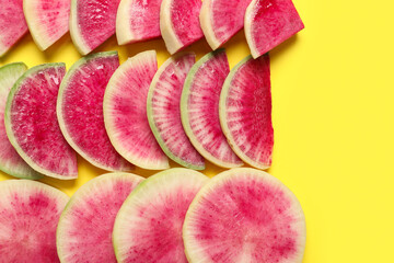 Cut ripe watermelon radishes on yellow background