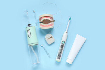Set for dental hygiene with oral irrigator on blue background