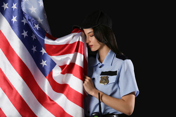 Female police officer with USA flag on black background