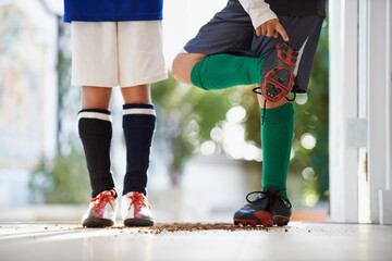 Soccer player, friends and cleats or sports athlete with dirt in home or competition game, workout...