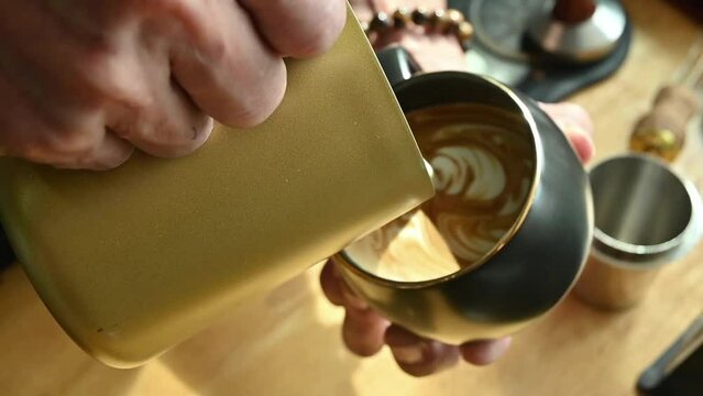 Video footage of barista pouring milk to make latte art coffee, Coffee shop business.