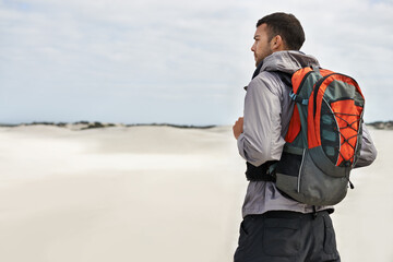 Hike, dunes and male person in nature for adventure, desert landscape and travel for holiday....