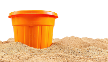 Orange kids bucket on the sandy beach isolated on transparent background