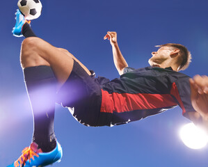 Football player, jump and kick with man and soccer ball, energy and challenge with skill in...
