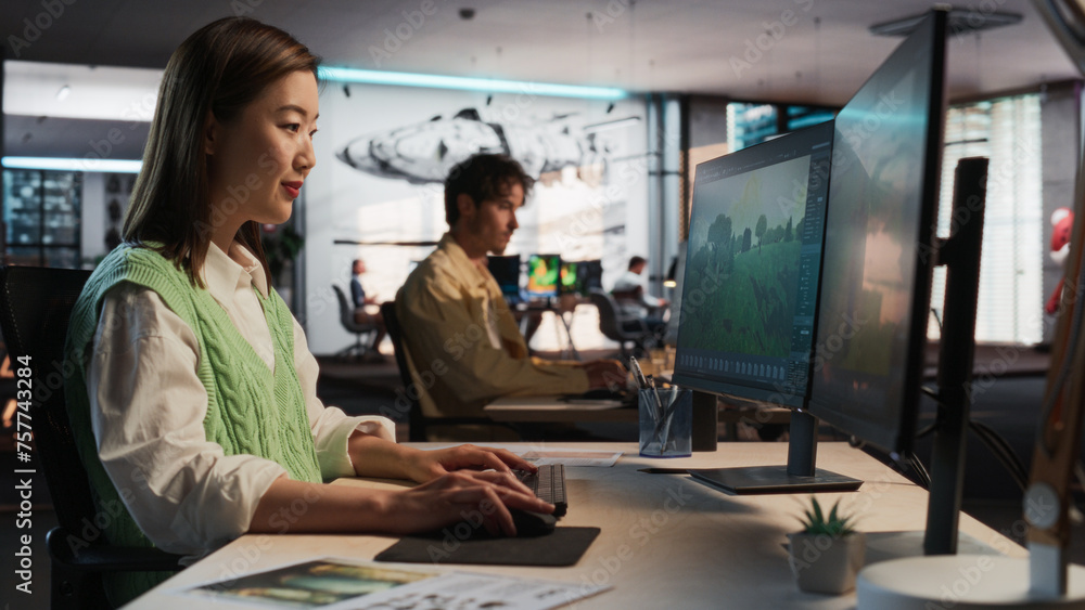 Poster Asian Woman Using Desktop Computer And Designing In 3D Modelling Software Unique World And Characters For Survival Video Game In Diverse Office. Female Game Designer Creating Immersive Gameplay