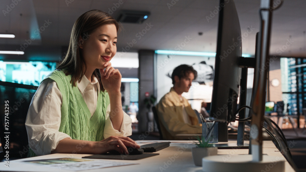 Poster Asian Woman Using Desktop Computer And Designing In 3D Modelling Software Unique World And Characters For Survival Video Game In Diverse Office. Female Game Designer Creating Immersive Gameplay