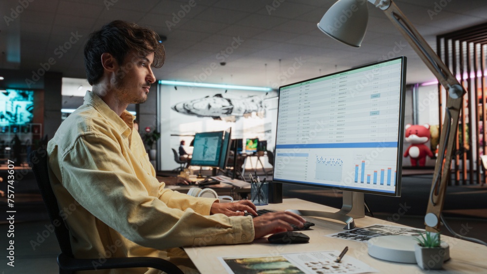 Poster Caucasian Male Manager Using Desktop Computer With Analytics Software wth Financial Reports. Man Working In Game Development Company Diverse Office