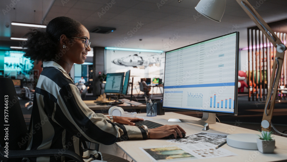 Poster African Female Manager Using Desktop Computer With Analytics Software wth Financial Reports. Woman Working In Game Development Company Diverse Office