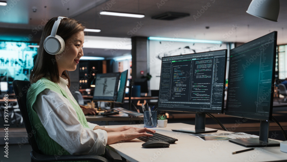 Aufkleber Female Asian Game Programmer Coding On Desktop Computer In Game Development Studio Diverse Office. Focused Woman Writes Lines Of Code, Does Gameplay Engineering For New Immersive 3D RPG Video Game.